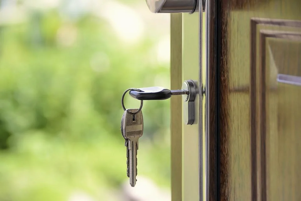 Keys hanging from the lock of a front door